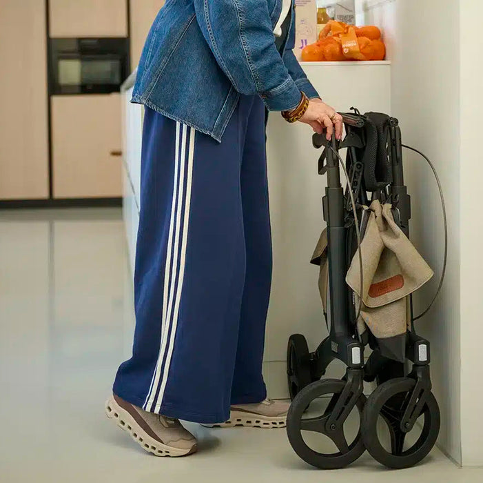 Rollz Flow Aluminum Walker In Granite Black Demonstrating The Easy Folding Mechanism.