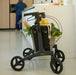 Rollz Flow Aluminum Walker In Granite Black Showing The Spacious Storage Underseat Bag Filled With Groceries.