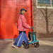 Rollz Flow Aluminum Walker In Granite Black Being Used By A Person Walking Outdoors.