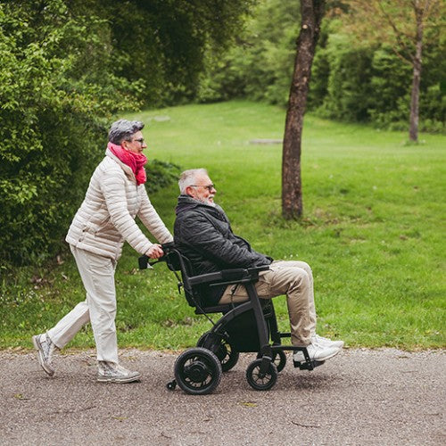 Rollz Motion Electric Wheelchair and Rollator Walker In Wheelchair With Patient Push By Caretaker View