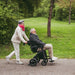 Rollz Motion Electric Wheelchair and Rollator Walker In Wheelchair With Patient Push By Caretaker View