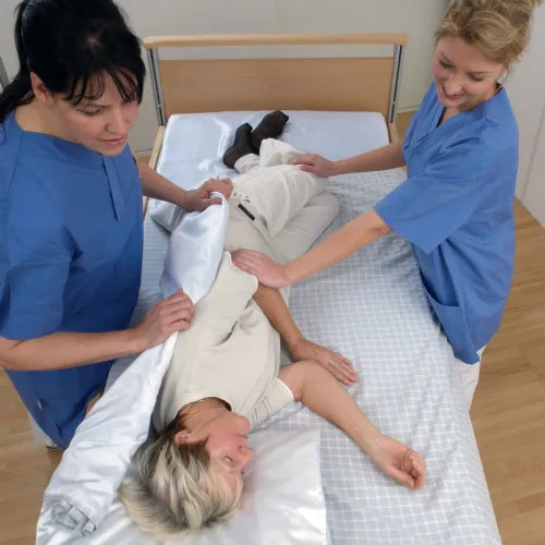 Savaria WendyLett 4 Way Sliding Drawsheet For Multidirectional Bed Mobility And Repositioning Featuring Patient Being Moved