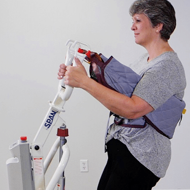 Span America Powered Sit-to-Stand Patient Lift For Home And Medical Use With Up To 500 Lb Capacity In Long Term Care Setting With Patient In Lift
