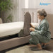 A woman in sage green pajamas kneels beside a bed with the Starsleep Orin Arlo Rotating Bed, demonstrating the side support panel that allows the mattress to tilt. The brand logo 'Arlo Rotating Bed' is visible in the top right corner.