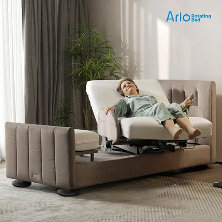 A woman relaxes in the Starsleep Orin Arlo ergonomic rotating chair bed, set in a modern living room with curtains, a plant, and a patterned rug. The brand logo 'Arlo Rotating Bed' is visible in the top right corner.