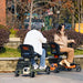 SuperHandy Passport Pro Foldable 4 Wheel Mobility Scooter With Rider And Storage Bag In Outdoor Different Color Rear View