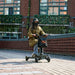 SuperHandy Passport Pro Foldable 4 Wheel Mobility Scooter With Rider And Storage Bag In Outdoor Front View