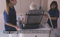 TR Equipment TR9650 Battery Operated Mobile Stretcher Lift With Caregiver And Patient Bathtub View