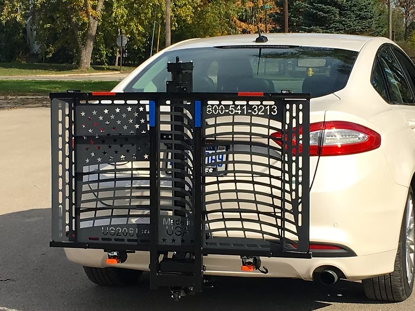 Wheelchair Carrier Patriotic Electric Lift Frame Folded Installed Into The Car Hitch Receiver View
