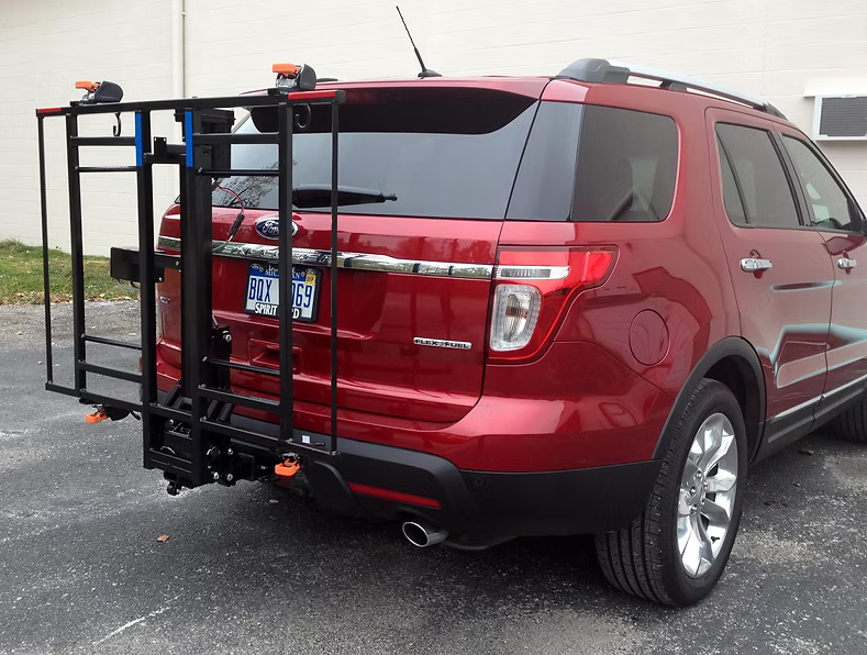 Wheelchair Carrier XL4 Electric Lift Installed Into Car Hitch Receiver Folded Side Angle View