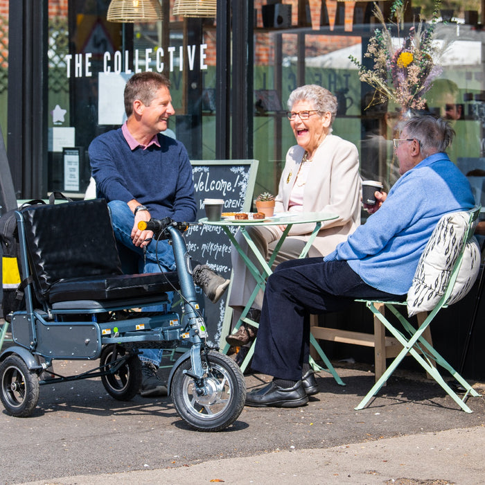 eFoldi Explorer Ultra Lightweight Scooter Easily Park In A Coffee Shop View